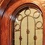Coto Wine Cellar Door in Knotty Alder with operable wrought iron and hand carved centerpiece
