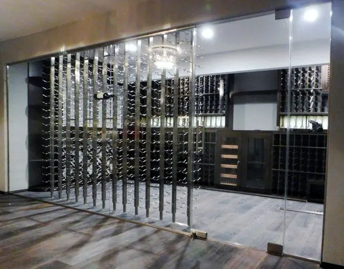Contemporary Home Wine Cellar with Seamless Glass Door and Walls