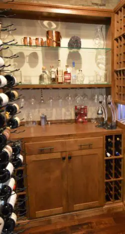 Glass was the third element needed to bring the wood and metal together and truly make the design of this custom wine cellar transitional!