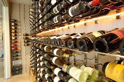 Wine Cellar with Attractive Lighting for Bottles in Metal Wine Racks Installed by Coastal Custom Wine Cellars