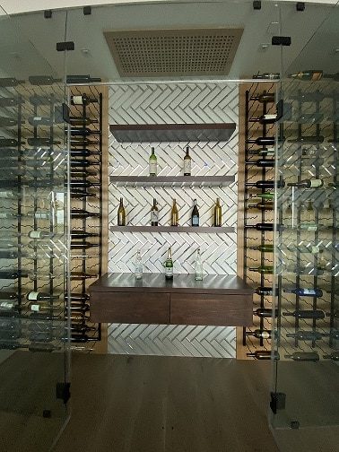 modern-glass-wine-closet-with-mirror-tiles-installed