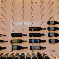 Peg racking on top of this illuminated panel makes it look like the wine bottles are floating in mid-air.