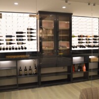 The cigar humidor is the central focal point of this beautiful residential wine cellar.