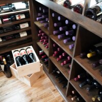 Large wooden bins like this are a wonderful way to store large amounts of wine bottles.