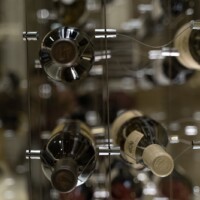 This modern glass wine cellar can hold 86 wine bottles.