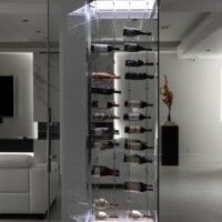 This incredible modern glass wine closet is an amazing addition to this California living room.