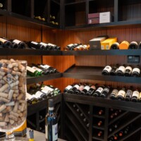 This transitional wine cellar features gorgeous custom wooden display rows with LED lighting.