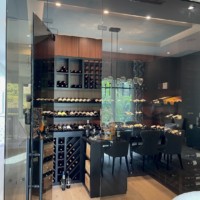 The glass walls in this home wine cellar protect and display the beautiful bottles inside.