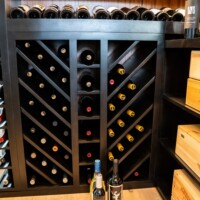 An innovative and beautiful design makes these wooden shelves an incredible element in this transitional wine cellar.