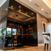 Transitional glass wine cellars like this one are a beautiful way to protect, store, and display your wine collection.