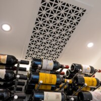 This custom grille protects and hides the industrial strength cooling unit overhead.