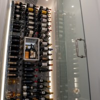 Modern wine cellars, large or small, can contain elements like metal racking, LED lighting, and glass walls and doors.
