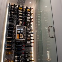 An LED backpanel adds to the mood and beauty of this small wine closet.