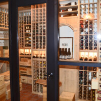 This rustic wine cellar design was crafted by masters and we always want to showcase them in a special way like putting in a framed-glass door!