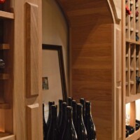 When you enter this wine cellar, the arched center will be one of the features you'll notice first. We purposefully added this onto this Miami home's wooden wine rack to provide more space for wine decanting and tasting. It also has ample space to display bottles in an upright manner.