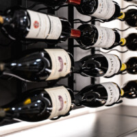 We used triple deep metal wine racks for this custom glass wine cellar's metal racking.