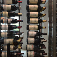The bottles here are held by triple-deep metal rods attached to a stainless steel column frame. They help organize your entire collection and allow you identify the bottles easily. This is just one of many custom wine rack ideas we can put on the table!