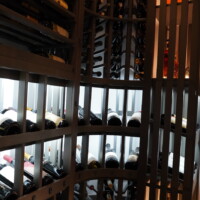 The entire wooden wine racking stands from floor to ceiling. We wove the different pieces together on site because it was just too large pre-assemble.