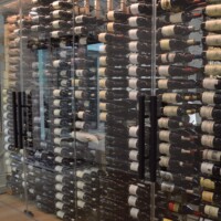 Matte black door handles were the choice for this glass wine cellar. They have the same color as our custom wine racks, and the idea was to match it as well with the dark tinted wine bottles.