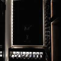 That light you see forming a rectangle are LED strip lights behind a thick, wooden backer board. We made sure our custom glass wine cellar featured more than just glass door panels, but also innovative wine racking displays.