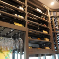The horizontal shelves in this wooden wine racking run deep. The width of it can accommodate three wine bottles, positioned horizontally.