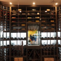 The main feature of this home wine cellar (apart from the wine collection) is the wooden wine racking that has different storage types. Bottles can be displayed here in different orientations, including label-forward, horizontal, cork-forward, and vertical.