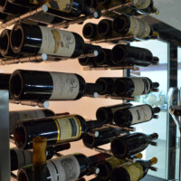 Glass wine cellars are very versatile when it comes to matching it with other design elements. Whether we pair it wood or metal racks, the output still comes together perfectly.