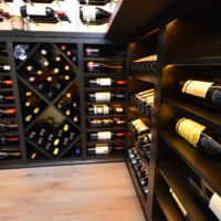 Glass wine cellar flooring can be made from hardwood, concrete, or reclaimed wine barrel.s For this wine room, we went with the same hardwood floors that were used in the living room.