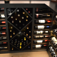 Since glass wine rooms are more oriented towards the modern style, we made sure to also incorporate an innovative wine cellar racking design. That includes combining different storage shapes which is evident in the photo.