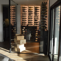 This glass wine room was built in an unused corner with this home's living room. It's not risky as long as it is built the right way, and that's what we guarantee our clients.