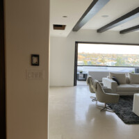 This modern wine room was set on an empty space within the living room. We had to demolish and redo the white walls to insert additional insulation and vapor barrier. Before Construction Photo of Modern Wine Rooms