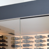 Small glass wine cellars or glass wine rooms are often fitted with split system cooling units to save space. In here, you only see two vents on the ceiling that facilitates air circulation in the cellar.