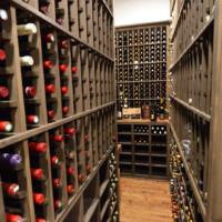 At the far end of this wine cellar, we built a table top into the custom wine rack to make space for decanters and larger bottles. Custom Wine Rack Table Top