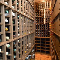 These custom wine racks stand more than 8 feet. You'll have to get a stool or ladder to reach the bottles on top. Massive Custom Wine Racks in Garage Cellar