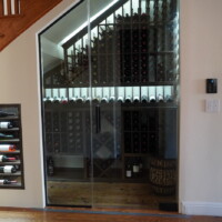 Since this wine cellar was rather compact, we decided that a frameless glass wine cellar door would create the illusion that the space was bigger. Refrigerated Glass Wine Cellar