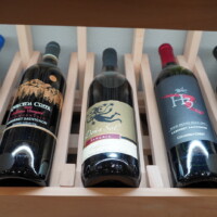 High-reveal racks displays wine bottles in a slanting, label-up position. This helps the owner and guests recognize the wines easily. These type of racking are commonly paired with standard 750 compartments around. Home Wine Cellar Display Section