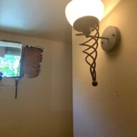 The old home wine cellar had a sconce light on the wall. Before Repair of Home Wine Cellar