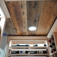 Look closely at this home wine room's ceiling and you'll notice the material isn't your typical wooden ceiling. The planks are actually repurposed wine barrels! Home Wine Room Custom Ceiling