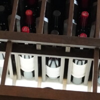 Our custom wooden wine rack in this refrigerated wine cellar is designed to welcome proper air flow. This approach allows cold air to reach different parts of the bottle, cooling them evenly. Underside of Refrigerated Wine Cellar Rack