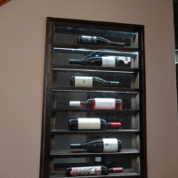 This small window display is illuminated by LED ribbon lights. Strips of LED were installed under each horizontal rack so it sheds light on each bottle. Refrigerated Wine Cellar Window Display