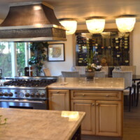 Even as the client is cooking in the kitchen, they will have a good view of their modern small wine cellar! Small Dining Wine Cellar Kitchen View
