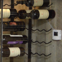 Sleek metal wine racks are more space savy than wooden wine racks. They're a must especially in small wine cellars like this one. Small Wine Cellar Space Savy Racks